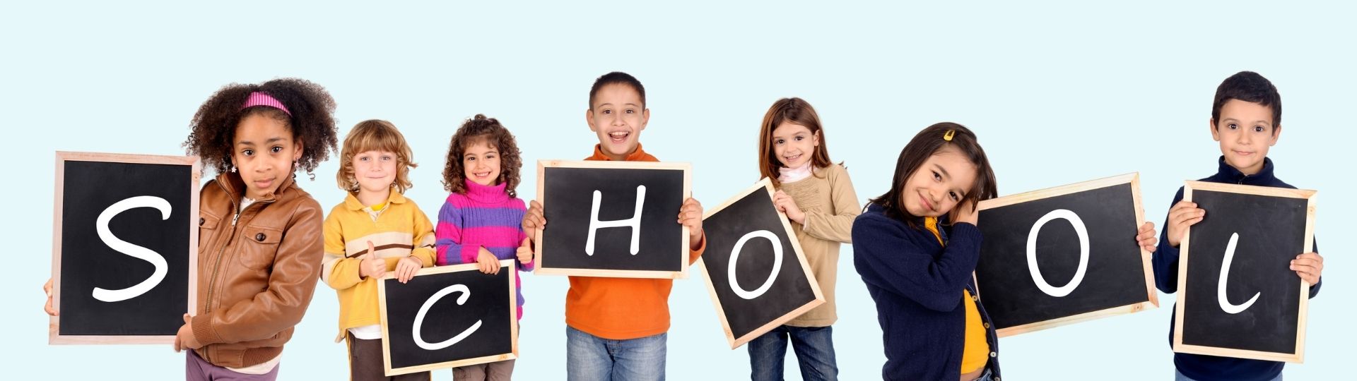 Photo of children holding chalkboards that spell out the word school